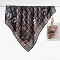 Detail of a plaid square silk scarf with butterfly prints draped over a white rod - Color 7