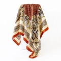 Detail view of paisley silk scarf with elegant folds over a white geometric block - 90x90cm / Yellow