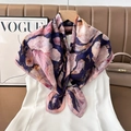 Detail of silk square scarf with blue and pink floral pattern styled on white vest - Color 15