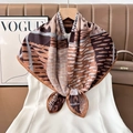 Detailed macro view of paisley patterned silk scarf hanging on a wooden hanger as an accessory - Color 17