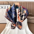Close-up of silk-feel paisley square scarf with abstract prints styled on a white dress - Color 2
