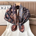 Detailed close-up of retro geometric patterned silk scarf hanging on a wooden hanger - Color 4