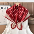 Detail of red silk scarf with white polka dots and rose patterns tied on a white top - Color 5