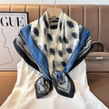 Close-up of blue and white silk square scarf with floral pattern on a hanger - Color 8