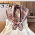 Classic red and yellow checkered silk square scarf tied on a white dress neckline - Color 10