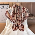 Detailed view of a luxury burgundy floral square silk scarf styled on a white dress - Color 20