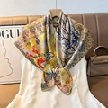Close-up of double-sided herringbone silk scarf with vibrant floral and paisley patterns - Color 23