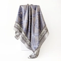 Detailed view of paisley satin square scarf draped over geometric blocks showing silk texture - 90x90cm (D9496) / Purple