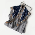 Dark blue silk scarf with white polka dots and paisley patterns on a grey vest - Blue