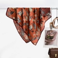 Rust red paisley printed silk scarf with floral patterns on white wooden hanger - Orange Floral Pattern