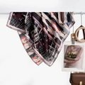 Elegant square scarf with geometric patterns in wine red and navy blue on a display bar - Geometric Line Patchwork