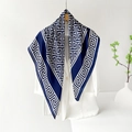 Dunkelblauer Seidenschal mit Mäander-Muster auf einem weißen Blazer für Damen - 90*90cm / Blau