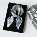 Detail of blue paisley satin scarf tied in a knot inside a black premium gift box - 70*70 (ai-Square) / Blue (L7523)