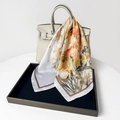 Detailed close-up of floral satin scarf tied on a luxury white leather handbag - 70x70cm / Abundant Flowers