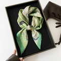 Detail of silk satin scarf with green oil painting print and dark green edges on a tray - 70x70cm / Green Plum