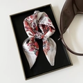 Detail of floral print satin scarf with smooth silk texture in a luxury display tray - 70x70cm / Rose Red