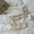 Detail of cream cashmere scarf showing fine knit texture, fringe tassels, and brand label - Milk White (LM01-01)
