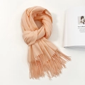 Detail of soft fringe tassels on a light apricot cashmere-feel scarf with magazine backdrop - 74.8*27.5inch / Glitter