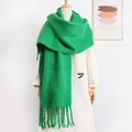 Vibrant green mohair scarf with thick long tassels on a white coat and wooden mannequin - Green