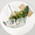 Detail of green pleated silk scarf with abstract gradient pattern on wooden props - Light Green Print