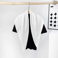 Detailed view of a white pleated silk-like satin scarf styled on a black t-shirt - Pleating / White