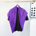 Detail of bright purple pleated satin scarf paired with a minimalist black knit top - Pleating / Purple