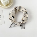 Macro detail of cotton silk square scarf featuring colorful horse print and brown hem - Horse Apricot