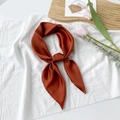 Detail of elegant caramel silk neck scarf with smooth satin finish and soft draping texture - Brown