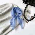 Elegant misty blue organza scarf with golden metal logo tag on casual grey fabric - 64x64cm / Blue