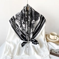 Detail of a black and white silk scarf with French toile print tied on a white shirt collar - Black