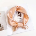 Detail of elegant champagne silk scarf texture with professional stitching and soft luster - Champagne