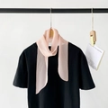 Pink pleated chiffon skinny scarf tied on a black shirt for a minimalist French look - Pink