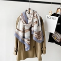 Detail of silk scarf with equestrian belt print draped over a trench coat - White (M8908)