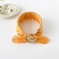Detail of bright yellow paisley bandana knotted design made of breathable fabric - 50cm x 50cm / Orange