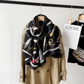 Detail of cotton linen scarf with gold chain print and fringe styled on a trench coat - Black (M8908)