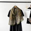 Close-up of olive green linen scarf featuring classic paisley patterns and geometric borders - Green Paisley Style (M8904)