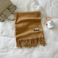 Camel colored virgin wool scarf with long fringe details on a soft white background - Camel