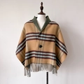 Detail view of the retro plaid shawl showing the thick fabric texture and button closure - Khaki Green