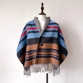 Detail of color block striped poncho featuring button closure and thick fringe hem - Light Blue Grey