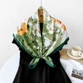 Silk-feel square scarf with green floral pattern and orange accents on dress - Green Floral Print