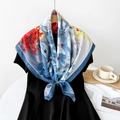 Floral twill silk scarf with red and blue pattern styled on a black dress - Blue Floral Print