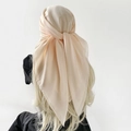 Back view of a large champagne silk scarf tied as a headwrap showing soft drape texture - Beige
