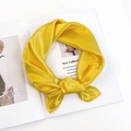 Elegant bright yellow satin silk scarf tied in a bow on a stylish magazine background - Goose Yellow