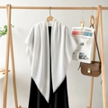 Detail of white cotton-linen shawl with fringe edges on a wooden hanger with retro props - White