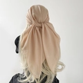 Detail view of the soft beige chiffon headscarf with smooth texture and draped finish - Champagne