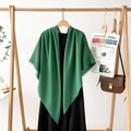 Detail of forest green pashmina shawl with tassel fringe draped over a black dress - Emerald Green
