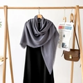 Detail of grey linen-feel shawl showcasing delicate fringe edges and soft drape - Dark Gray