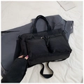 Top view of a black multi-pocket utility tote bag with sturdy woven straps and metal zippers - Black