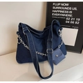 Detail of blue denim tote bag showing white stitching, metal chain and small pouch - Dark Blue