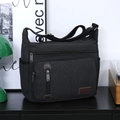 Men's black canvas messenger bag with adjustable shoulder strap and multiple compartments - Black